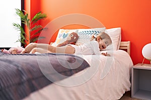 Adorable caucasian girl smiling confident lying on bed at bedroom