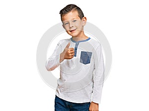 Adorable caucasian kid wearing casual clothes doing happy thumbs up gesture with hand