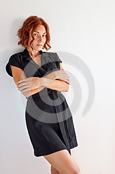 Adorable caucasian lady with natural red hair posing  on white