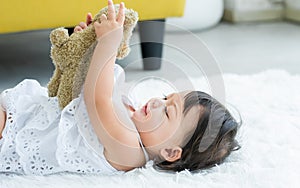 Adorable caucasian little baby daughter kid girl, laughing, smiling with happiness, good health, relax day sleeping, laying down