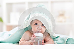 Adorable child baby drinking water from bottle photo