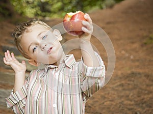 Adorable Child Boy Eating Red Apple Outside