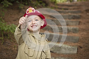 Adorable Child Boy with Fireman Hat Playing