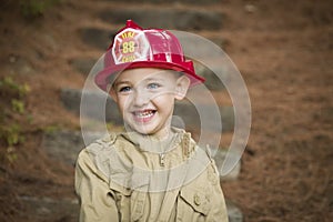 Adorable Child Boy with Fireman Hat Playing Outside