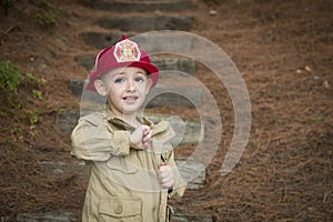 Adorable Child Boy with Fireman Hat Playing Outside