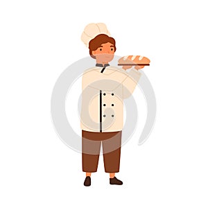 Adorable child, cute boy in chef baker uniform. Boy in cooking toques, serving wheat bread, baguette. Kitchen chief cook