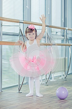 Adorable child dancing classical ballet in studio.