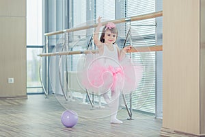 Adorable child dancing classical ballet in studio.