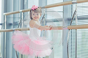 Adorable child dancing classical ballet in studio.