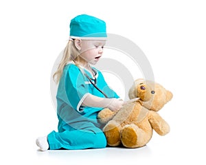 Adorable child dressed as doctor playing with toy