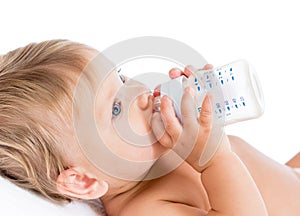 Adorable child drinking from bottle