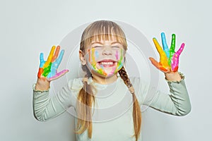Adorable child girl art school student showing her colorful painting hands on white background portrait