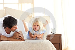 Adorable child having discussion with her father