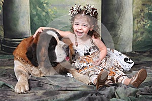 Adorable Child and Her Saint Bernard Puppy Dog