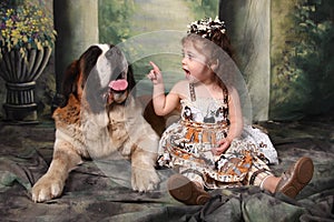 Adorable Child and Her Saint Bernard Puppy Dog