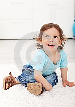 Adorable child laughing on the floor