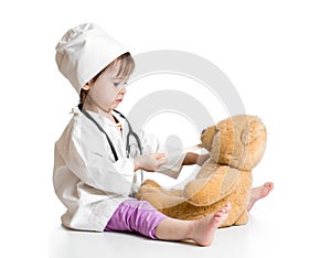 Adorable child playing doctor with toy