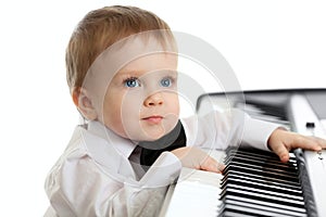 Adorable child playing electron piano