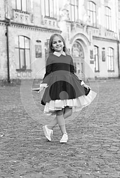 Adorable child wear classy uniform dress with elegant look in schoolyard, school