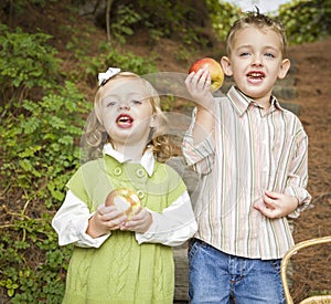 Adorable Children Eating Red Apples Outside