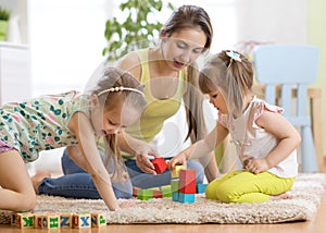 Adorable children with mom playing colorful toys