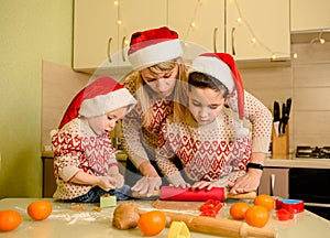 Adorable children and mother cooking Christmas cookies at home. Baking