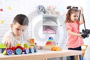 Adorable children playing in light room