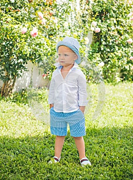 Adorable cool summer style child boy oudoor. Kids fashion. photo