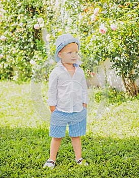 Adorable cool summer style child boy oudoor. Kids fashion.
