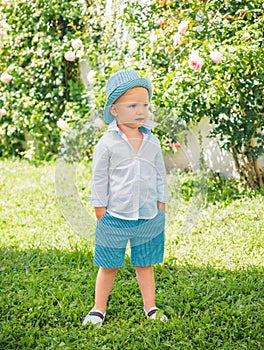 Adorable cool summer style child boy oudoor. Kids fashion. photo