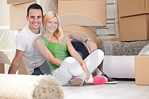 Adorable couple sitting in new home