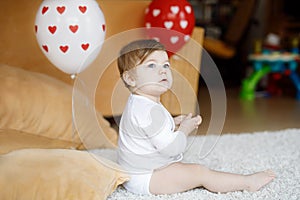 Adorable cute beautiful little baby girl playing with educational toys at home or nursery.