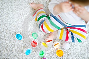 Adorable cute beautiful little baby girl playing with educational toys at home or nursery. Happy healthy child having