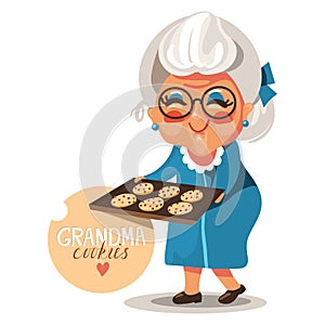 Grandmother grandma in a blue dress and glasses with cooked, fresh baked cookies photo