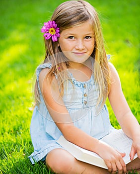 Adorable cute little girl reading book