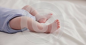 Adorable, family and feet of baby on bed for child care, relax and resting in nursery. Innocent, cute and closeup of