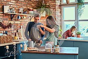 Family together cooking breakfast in loft style kitchen.