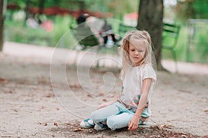 Adorable fashion little girl outdoors in the Tuileries Gardens, Paris