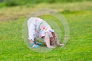 Adorable funny baby girl with her head down