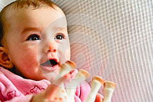 Adorable funny baby girl smiling with pink pajamas