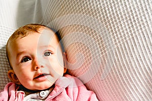 Adorable funny baby girl smiling with pink pajamas