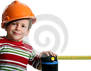 Adorable future architect in helmet with rule