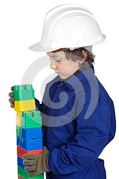 Adorable future builder constructing a brick wall with toy piece