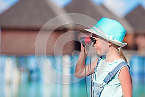 Adorable girl with binoculars during beach summer