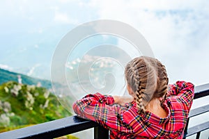 Adorable girl in the cabin on the cable car in mountains