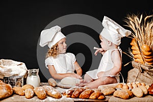 Adorable girl with child on table cooking