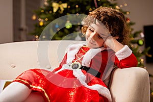 Adorable girl in Christmas dress near the classic decorated christmas tree
