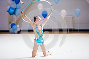 Adorable girl competing in rhythmic gymnastics