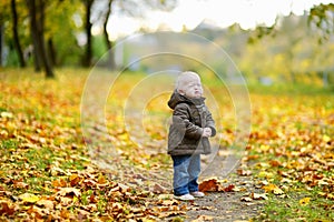 Adorable girl crying on beautiful autumn day