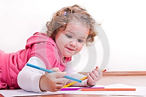 Adorable girl is drawing